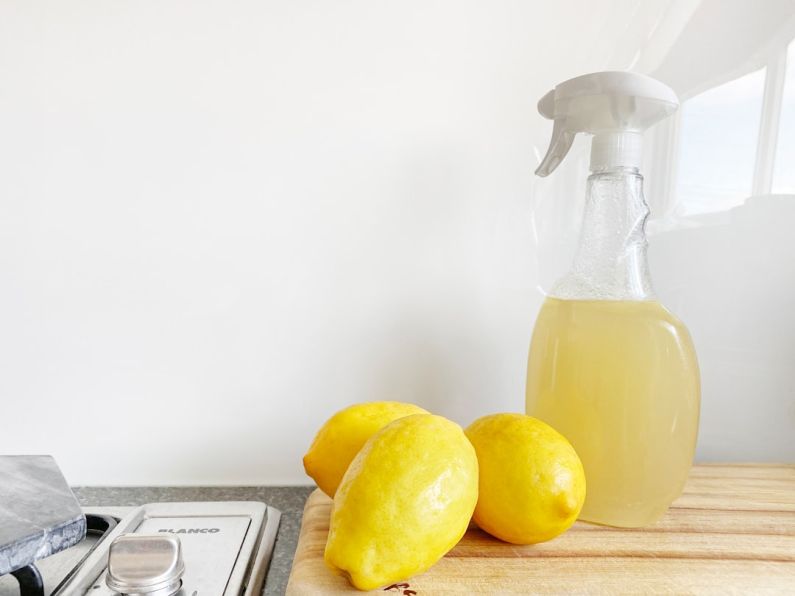 Natural Cleaning - yellow lemon fruit beside clear glass bottle