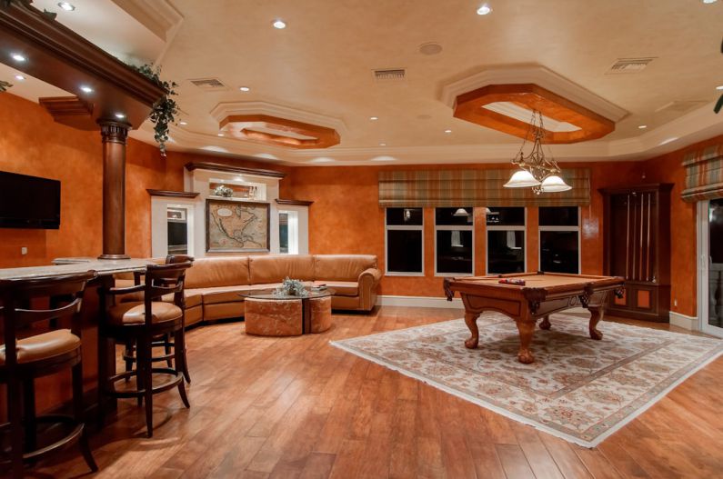 Home Gym Flooring - billiard table in center of brown painted room