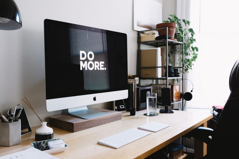 Dual-purpose Furniture - silver iMac with keyboard and trackpad inside room